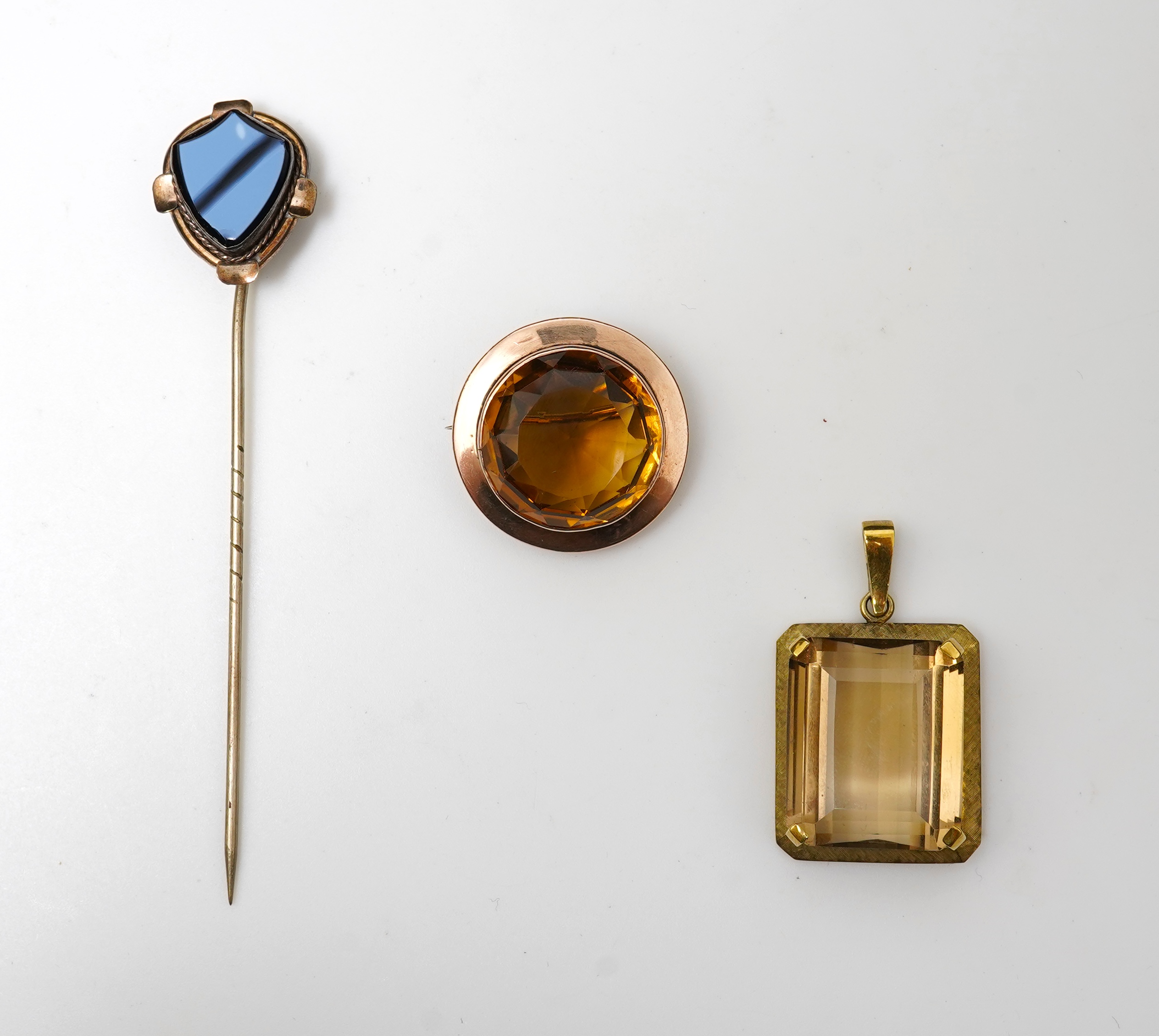 A citrine brooch and pendant, and onyx stickpin